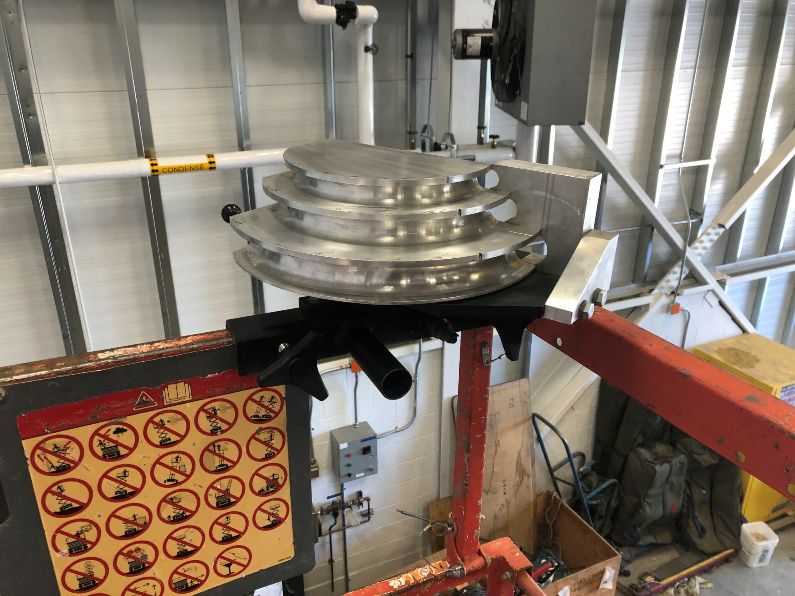 Skybender EMT conduit bender attached to the corner of a scissor lift guardrail