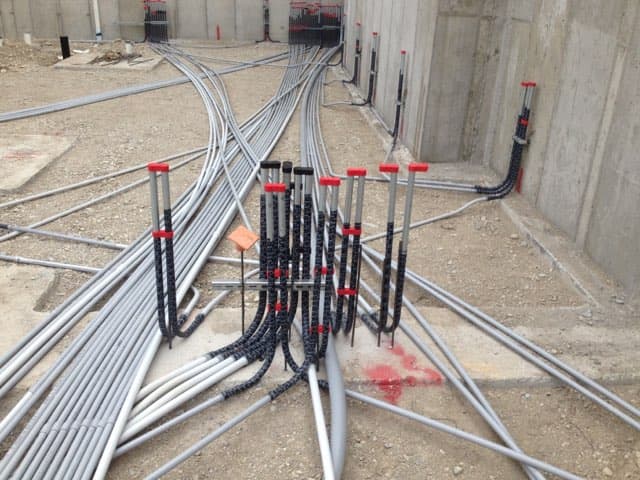 stubbed conduit connected with slammers conduit spacers and protected with slammers conduit caps for a concrete slab pour