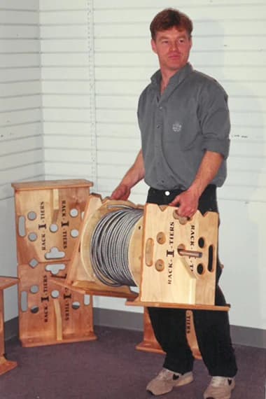 Ken installing electrical wiring with a Rack-A-Tiers cable caddy